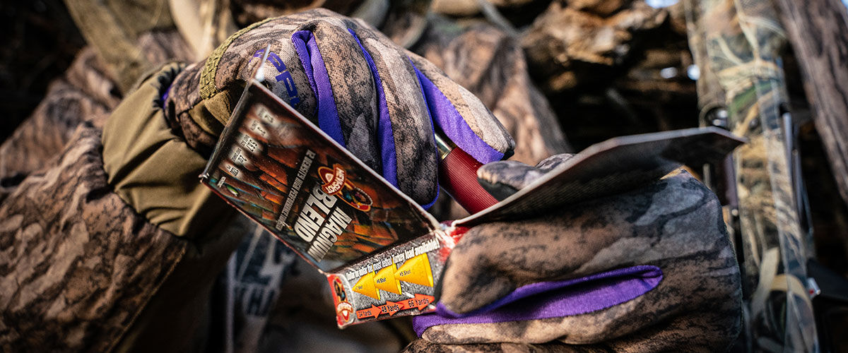 Hunter pulling Magnum Blend shotshells from the box