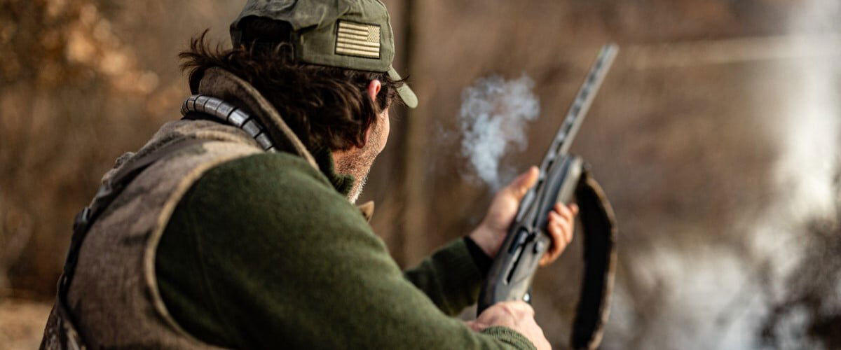 shooting holding shotgun