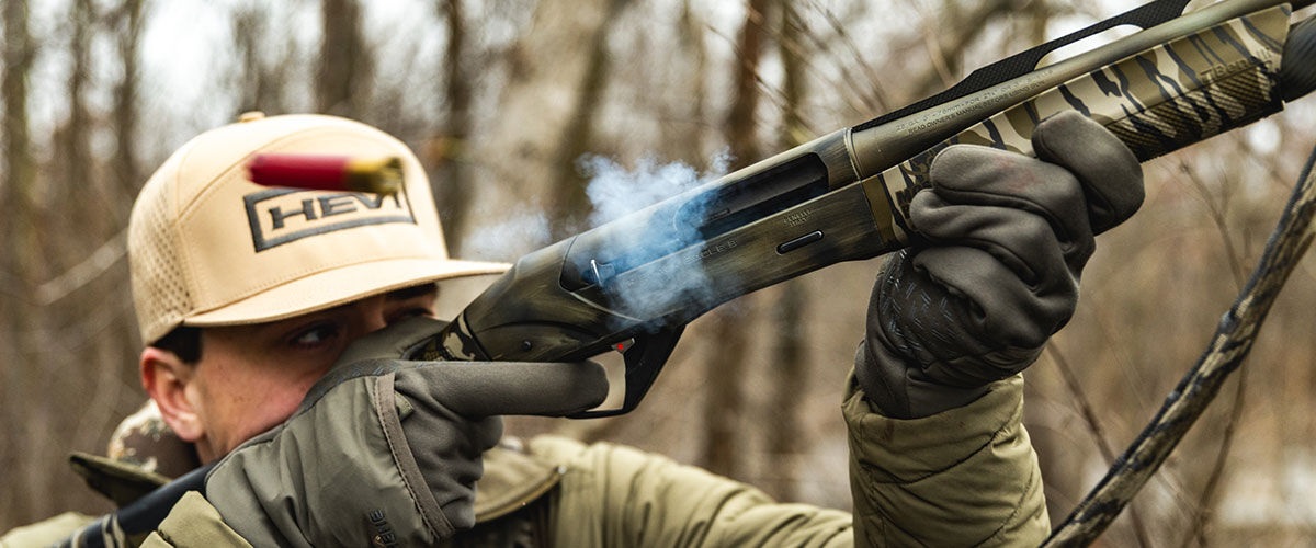 hunter shooting a shotgun